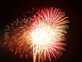 Low angle view of firework display at night