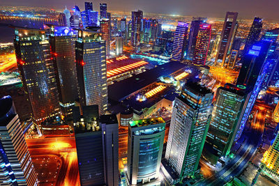 Aerial view of city lit up at night