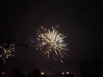 Low angle view of firework display at night