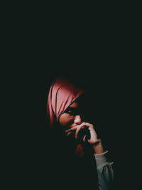 Full length portrait of man against black background