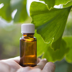 Close-up of hand holding glass bottle