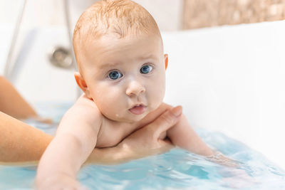 Close-up of cute baby girl in bathtub