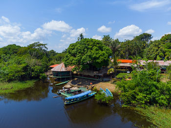 Aerial view of a local guest house in the amazon rainforest with a little pier and wooden shacks