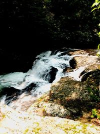 Scenic view of river flowing through rocks