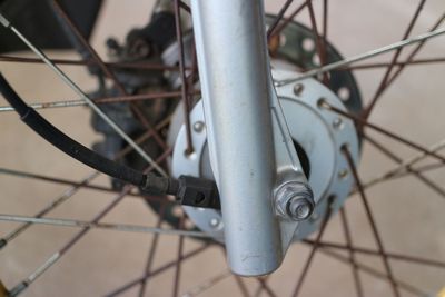 Close-up of bicycle wheel against wall