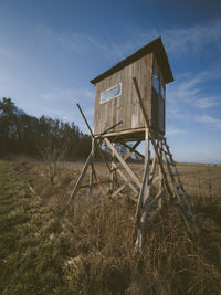 Abandoned built structure on field against sky