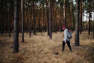 Full length of man standing on field in forest