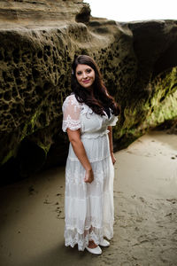 Portrait of a smiling young woman standing on land