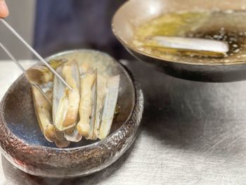 High angle view of razor clams in bowl on table