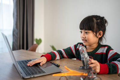 Boy using laptop at home