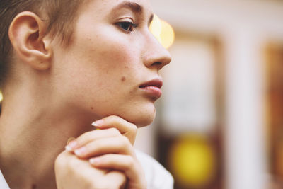 Close-up of young woman looking away