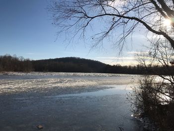 Scenic view of frozen lake against sky during winter