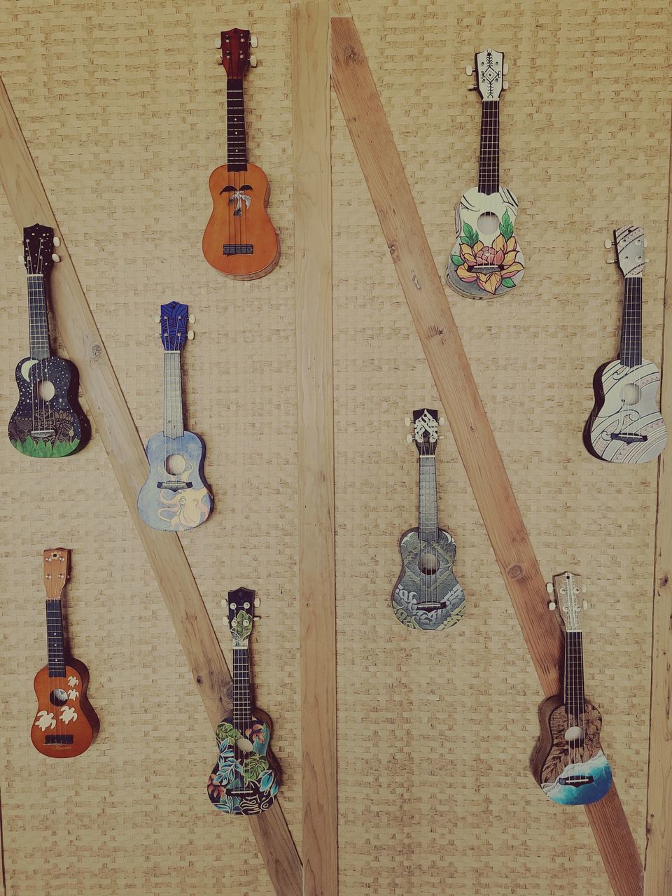 guitar, string instrument, wood, plucked string instruments, variation, indoors, no people, musical instrument, hanging, music, wall - building feature, arrangement, large group of objects, still life, musical equipment