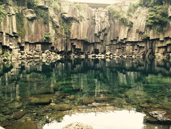 Reflection of rocks in lake water