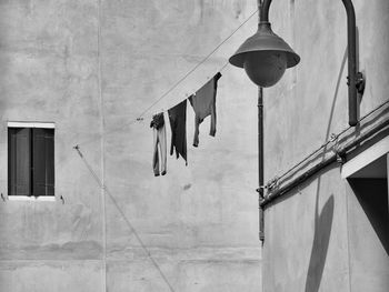 Low angle view of clothes drying against building