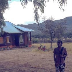 Man standing on field against sky