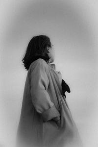 Low angle view of woman standing against sky