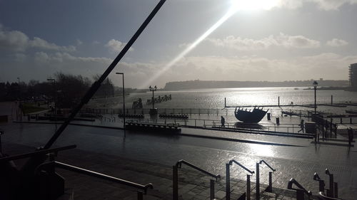 Sun shining through clouds over sea