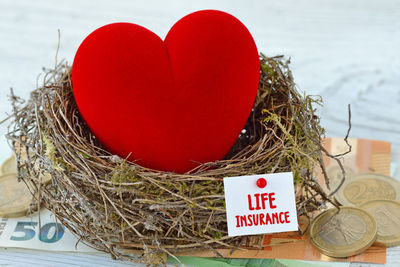 Close-up of red heart shape hanging on tree