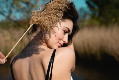 Rear view of woman against plants