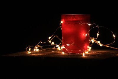 Close-up of illuminated lamp against black background