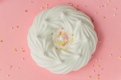 Directly above shot of ice cream over pink background