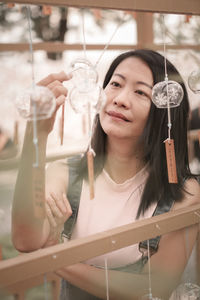 Portrait of smiling young woman drinking glass