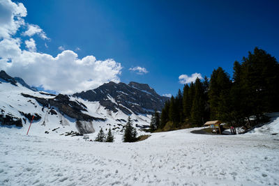 Scenic view of snow covered mountains against sky