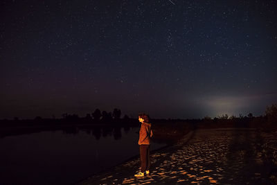 The girl on the shore is sad. raise your head to see a shooting star and make a wish. dream on. 