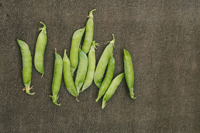 Fresh green peas on brown background