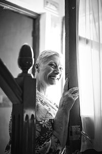 Portrait of smiling man on window