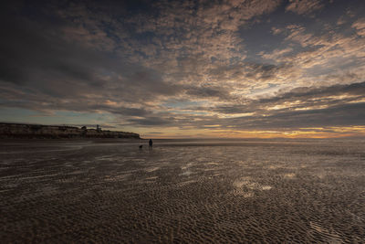 Scenic view of beach against sky during sunset