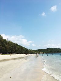 Scenic view of beach against blue sky