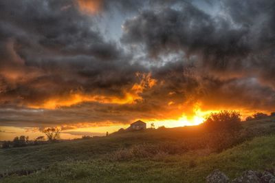 Scenic view of landscape against dramatic sky