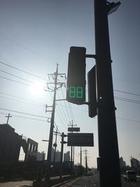 Low angle view of road signal against sky