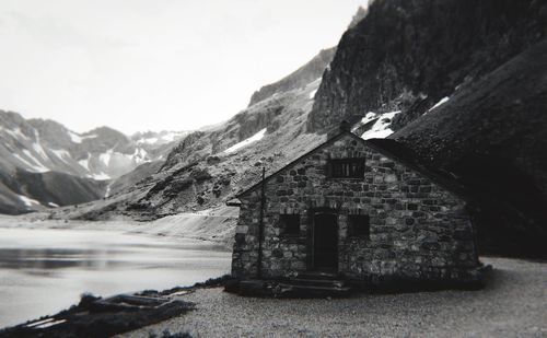 Scenic view of building and mountains against sky