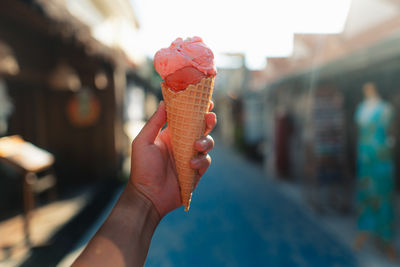 Close-up of hand holding ice cream cone