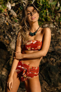 Young woman wearing fashionable bikini at beach