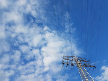 Low angle view of birds flying against sky