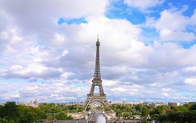 Communications tower against cloudy sky