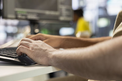 Cropped hand using laptop