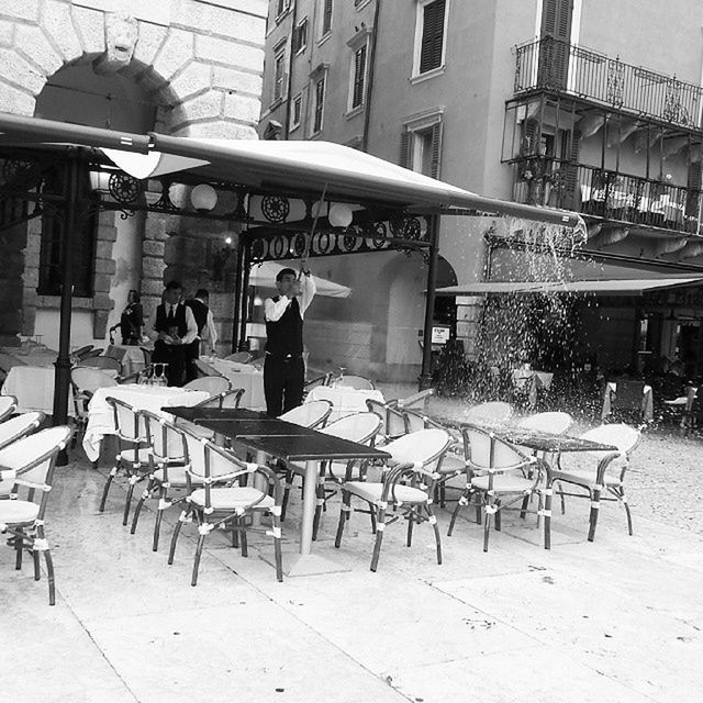 chair, men, person, lifestyles, leisure activity, built structure, table, architecture, sitting, building exterior, relaxation, retail, restaurant, sidewalk cafe, day, rear view, cafe, working