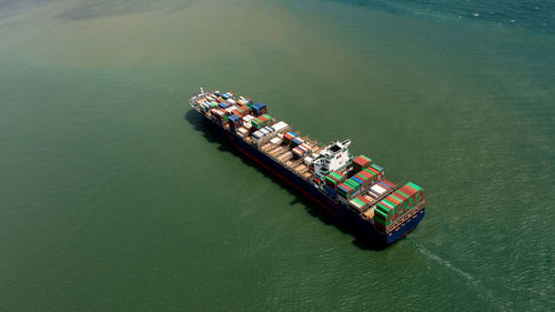 Container ship export and import business services and logistics. shipping cargo to harbor transport 