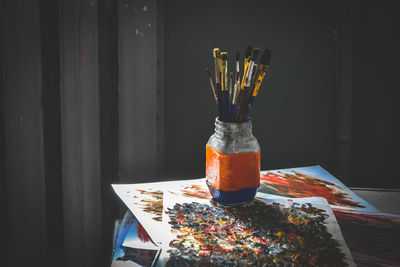 Close-up of multi colored paintbrushes on table