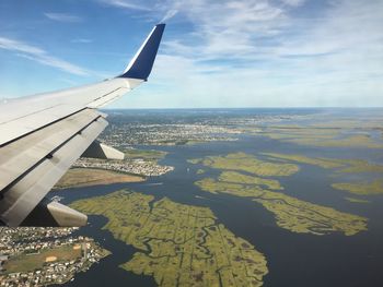 Aerial view of airplane wing against sky