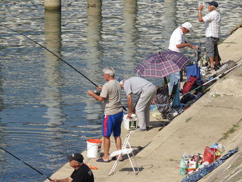 High angle view of people fishing at shore