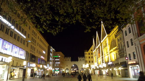 Illuminated city against sky at night