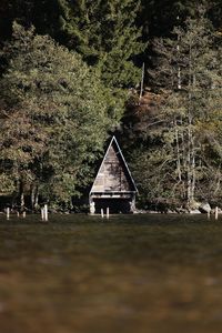 Gazebo by trees against sky