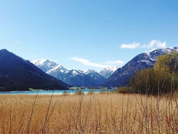 Scenic view of mountains against blue sky