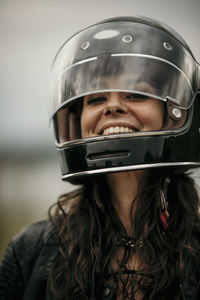 Happy woman with long hair wearing helmet